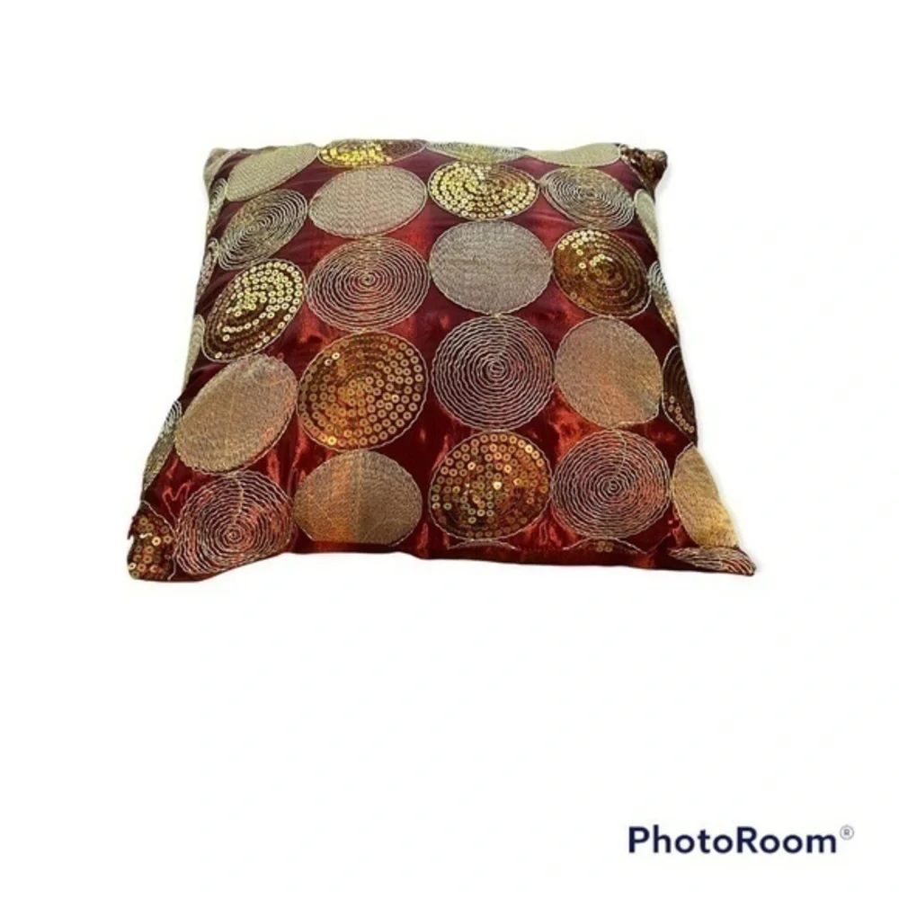 Dark red pillow with gold accents
